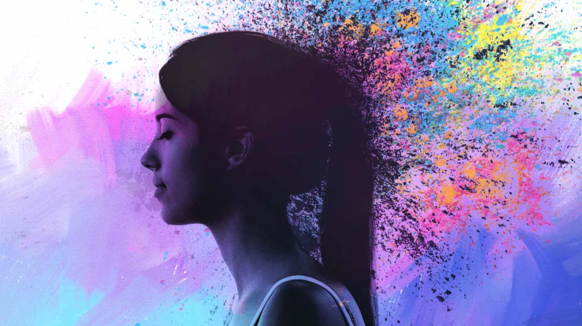 Foto de perfil de uma mulher, dos ombros até a cabeça, com partículas coloridas emanando de seus cabelos